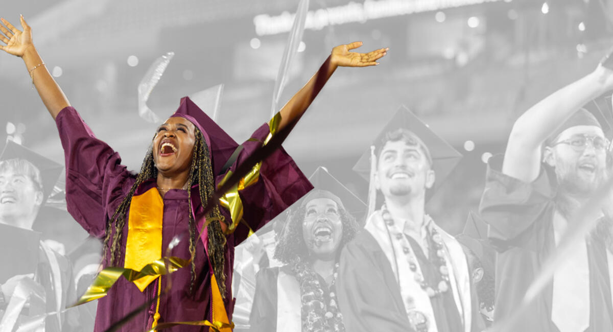 ASU student smiling while graduating